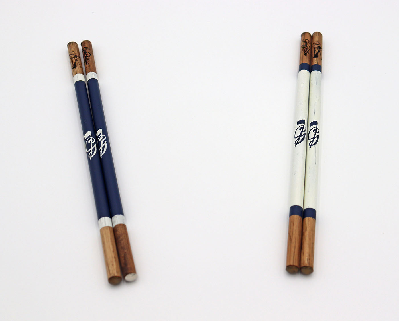 Product image of two sets of handcrafted hickory golf alignment sticks with custom Good Fellow Golf logos.
