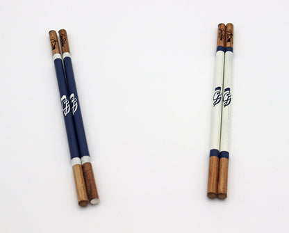 Product image of two sets of handcrafted hickory golf alignment sticks with custom Good Fellow Golf logos.